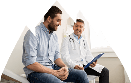 Male doctor sitting and talking with male patient.