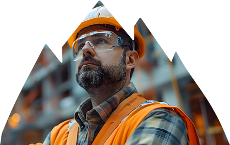 Construction worker deep in thought wearing safety goggles, hard hat and vest.