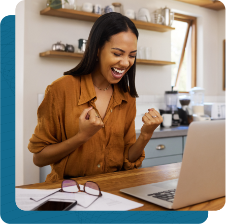 Woman happily looking at her laptop