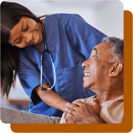 Female nurse caring for elderly male patient.