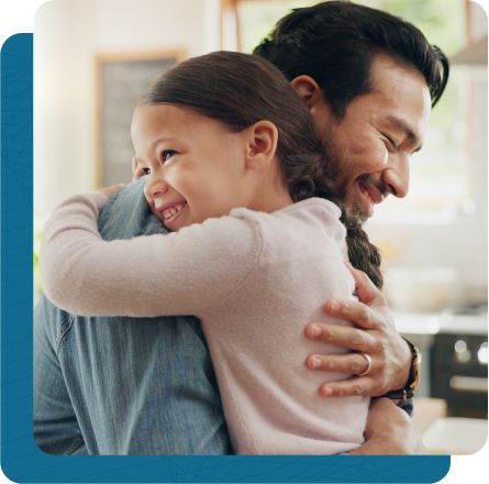 Father and young daughter embracing in a hug.