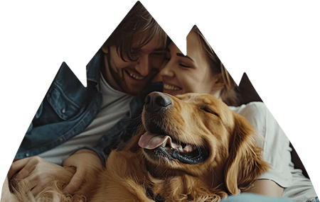 Couple laying together and holding dog.