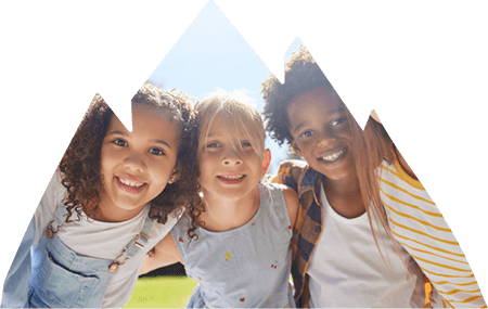 Young group of girls and boy smiling for picture.